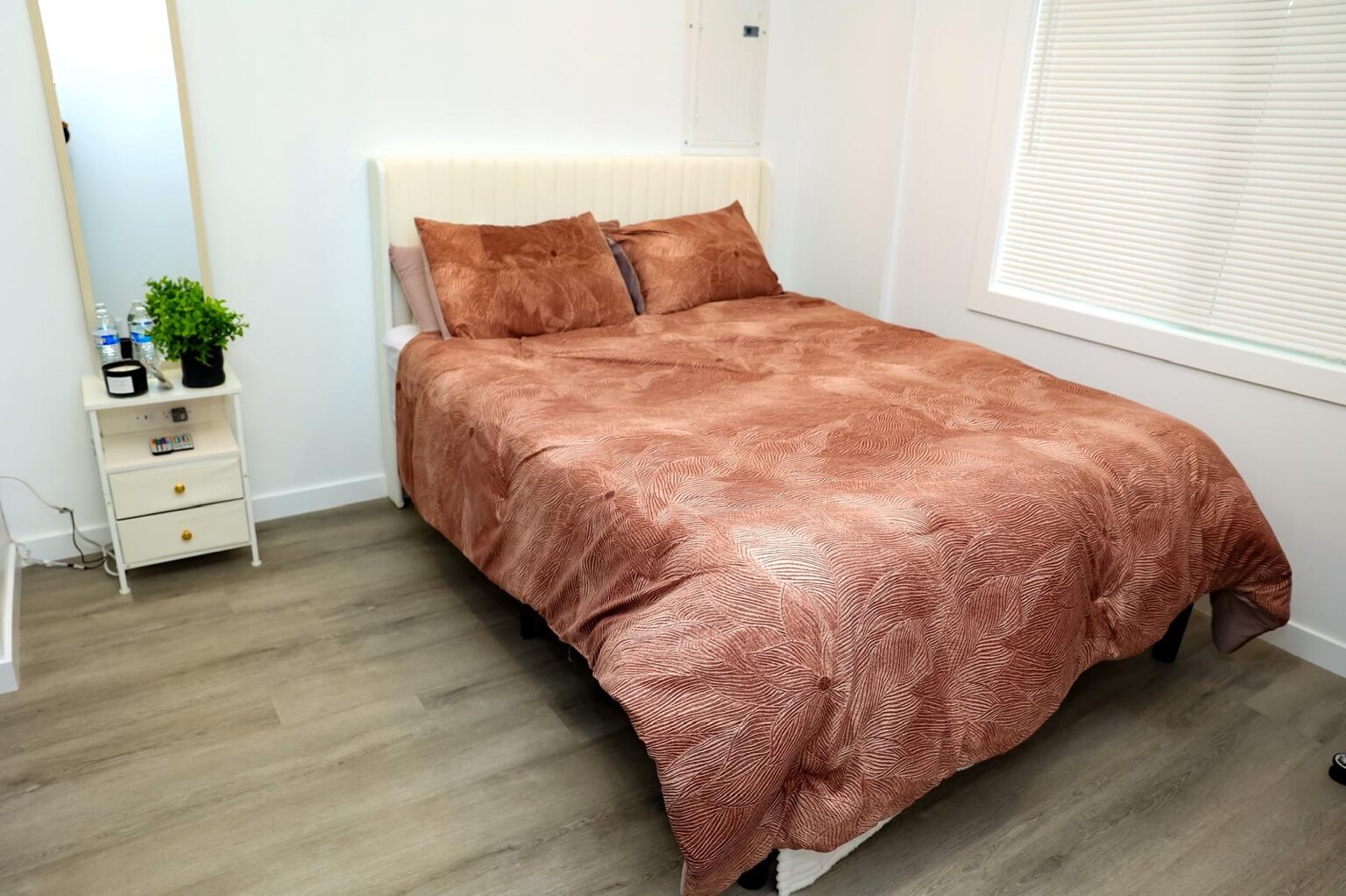 Furnished private bedroom with a large window